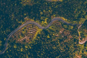 pexels-photo-1064129-1064129 Explore the mesmerizing aerial view of a winding road cutting through the dense forest in Batang Kali, Malaysia.