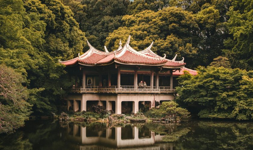 pexels-photo-2758567-2758567 A beautiful traditional Japanese pagoda surrounded by lush greenery and reflected in a peaceful lake.